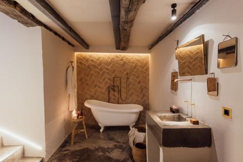 a bathroom with a tub and a sink at SOLO PALACIO - Boutique Hotel & Spa in Llanuces