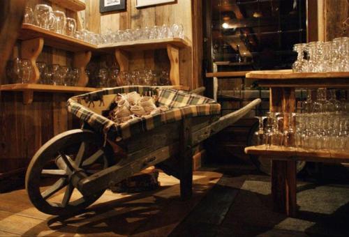 a cart in a room with glasses and a table at La Rêverie de Thumel - Suite in Rhêmes-Notre-Dame