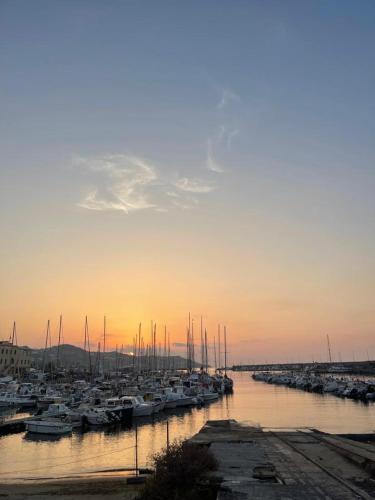 a group of boats docked in a harbor at sunset at House Gaudio 38 in Sanremo