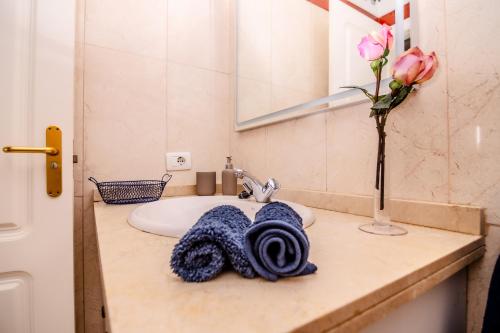 a bathroom sink with a towel on a counter at Mambo Palm-Mar apartment in Palm-mar