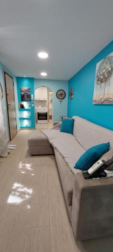 a large bed in a room with a blue wall at Guesthouse Aggelos Porto Germeno in Porto Germeno