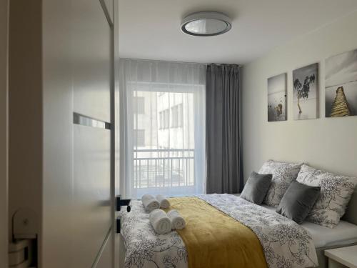 a bedroom with a bed with two towels on it at Widok Kielce - Apartament przy Rynku in Kielce