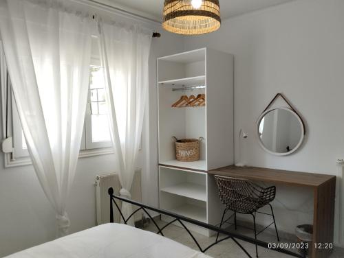 a bedroom with a mirror and a chair at SnD Rentals -Boutique apartments in Kozani