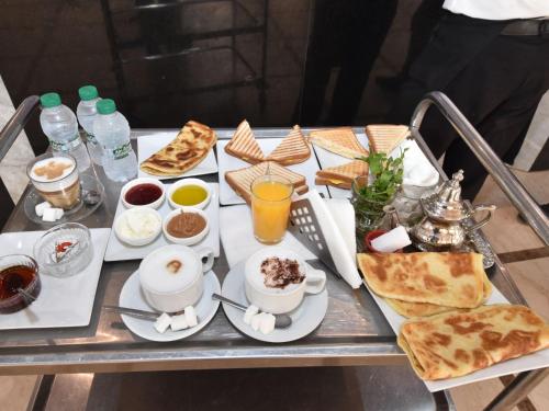a table with a tray of breakfast food on it at Perle de Souihla in Oulad Sidi Cheïkh