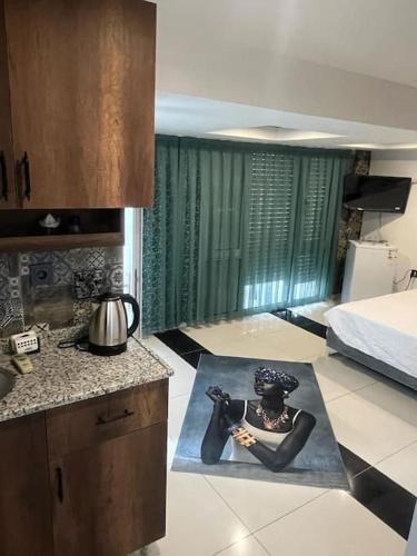 a kitchen with a picture of a woman on a rug at Africa in the heart of city center in Antalya