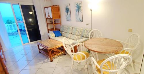 a living room with a table and a couch at Bungalow mit Meerblick in Costa Calma