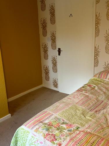 a bedroom with a bed with a pineapple wallpaper at Double Room Rent in Birmingham
