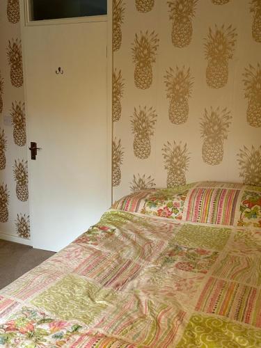 a bedroom with a bed with pineapple wallpaper at Double Room Rent in Birmingham