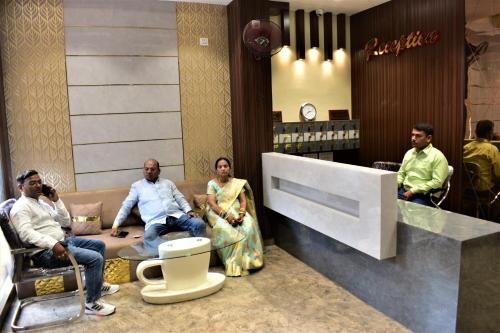 a group of people sitting in a waiting room at Hotel Kusum Palace in Gaya