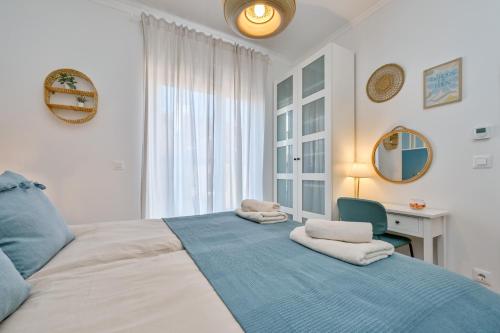 a bedroom with a large bed with towels on it at Apartment Zicer in Zagreb