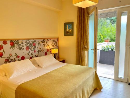 a bedroom with a bed and a sliding glass door at Casa Dolce Casa Ruvo Breakfast & bed in Ruvo di Puglia