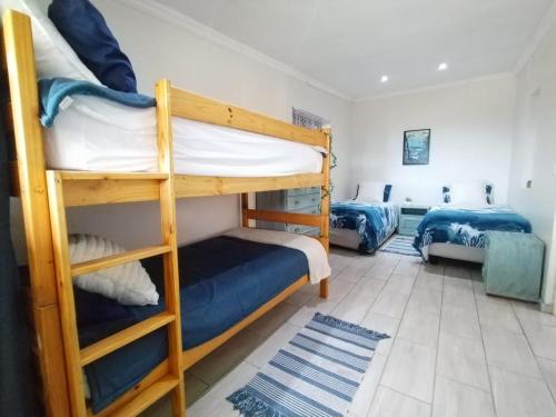 a room with two bunk beds in a room at HomeAway Beach House in Port Edward