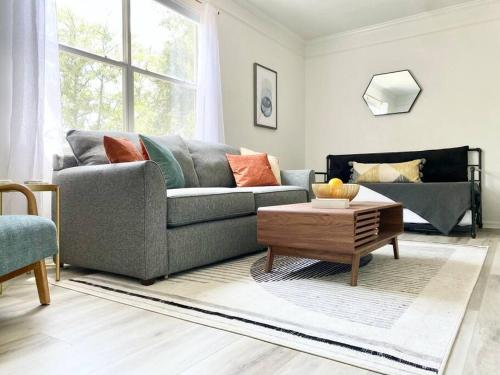 a living room with a couch and a coffee table at Sanctuary Gainesville Bright 2 BR King Condo in Gainesville