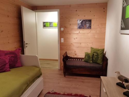 a living room with a couch and a door at Modern apartment with an amazing view in Leysin