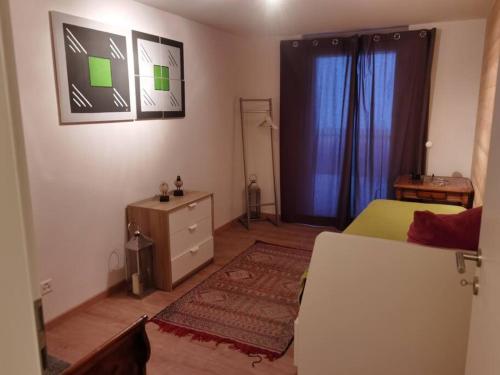 a living room with a bed and a dresser and a bedroom at Modern apartment with an amazing view in Leysin