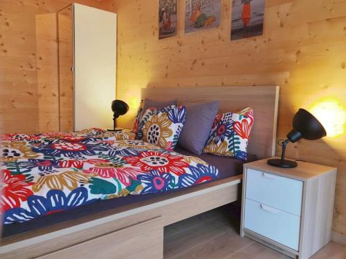 a bedroom with a bed and a lamp on a night stand at Modern apartment with an amazing view in Leysin