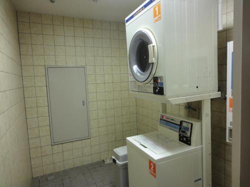 a small bathroom with a washing machine and a washer at EN RESORT Re'Cove Hakone in Hakone