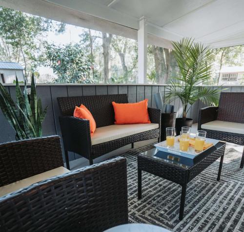 a patio with chairs and a couch and a table at Sanctuary High Springs New Reno Family-Friendly in High Springs