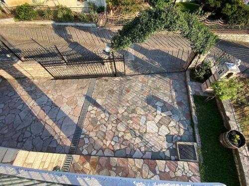 an overhead view of a stone walkway with trees and shadows at Casa Mirabella 
