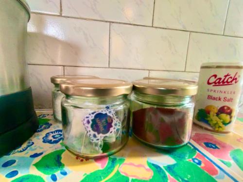 two jars of jam sitting on a colorful table at UVs Homestay in Haridwār