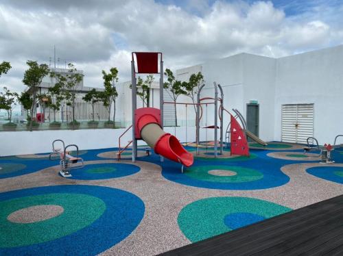 a playground with a slide and slides at Damen's 2BR Cozy Corner Near Sunway in Subang Jaya
