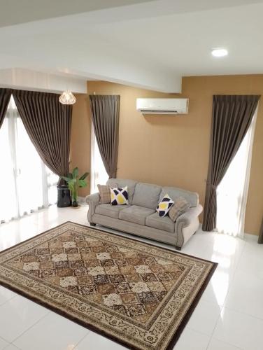 a living room with a couch and a rug at Pinevalley Homestay Putrajaya Presint 12 in Putrajaya