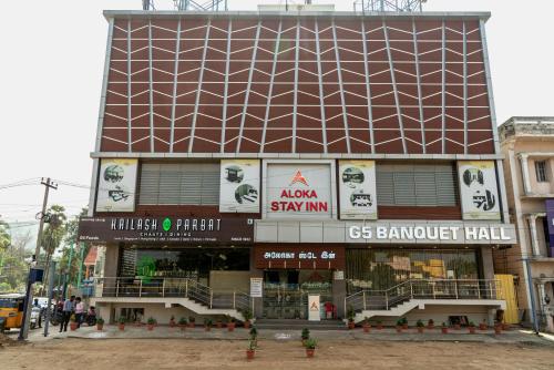 a large building with a sign on the side of it at Aloka Stay Inn in Vellore