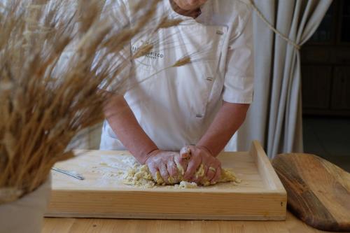 a chef is preparing food on a cutting board at Masseria Grieco in Ostuni