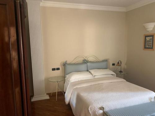 a bedroom with a large bed with a blue headboard at b&b Antiche Dimore Taurasi in Taurasi