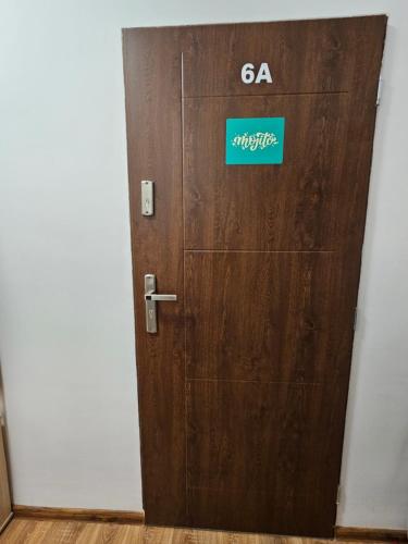 a wooden door with a sign on it at Apartamenty KoktajLOVE in Kielce