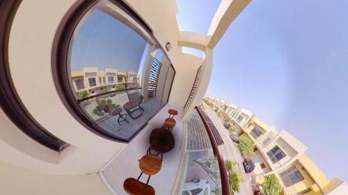 a round mirror on the side of a building at Romantic Hideaway, 1-BHK Villa in Dubai