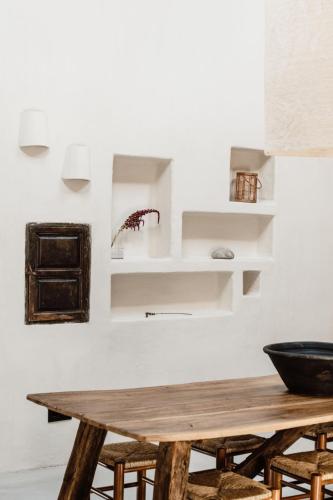 a dining room with a wooden table and chairs at Aguamadera in Santa Eularia des Riu