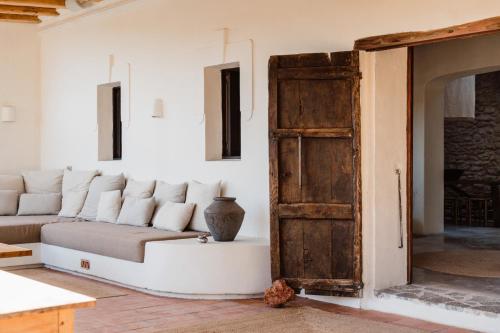 a living room with a couch and an open door at Aguamadera in Santa Eularia des Riu