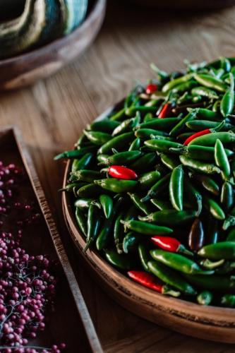 a plate of chili peppers on a wooden table at Aguamadera in Santa Eularia des Riu