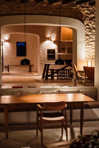 a living room with a table and chairs and a couch at Aguamadera in Santa Eularia des Riu