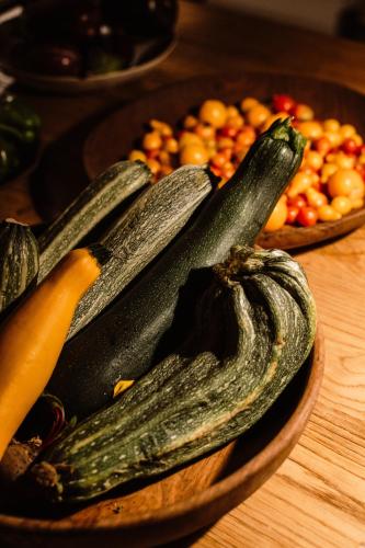 a bunch of cucumbers on a wooden plate on a table at Aguamadera in Santa Eularia des Riu