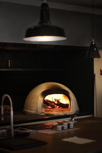 a pizza oven with a fire inside of it at Aguamadera in Santa Eularia des Riu