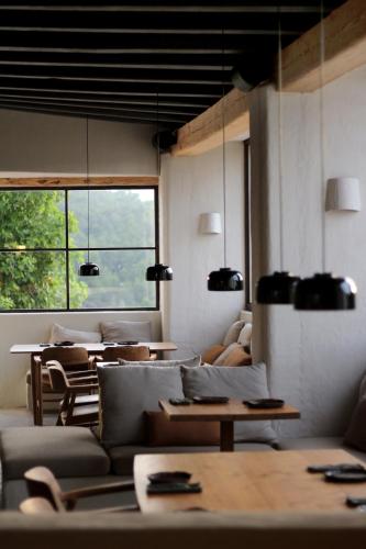a living room with couches and tables and a window at Aguamadera in Santa Eularia des Riu