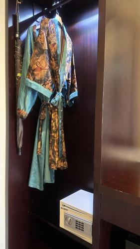 a group of clothes are hanging on a wall at The Quin Riverside Villa in Hoi An