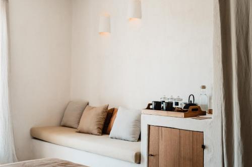 a white couch with pillows on it in a room at Aguamadera in Santa Eularia des Riu