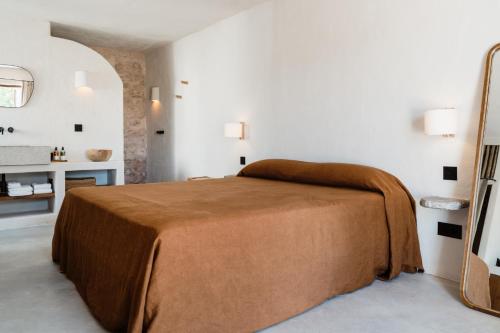 a bedroom with a bed with a brown blanket at Aguamadera in Santa Eularia des Riu