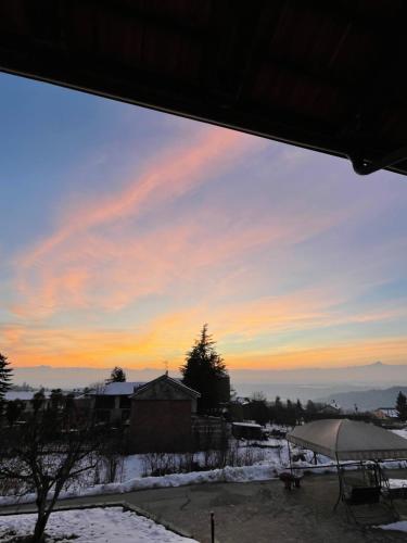 a view from a window of a sunset at Agriturismo Le Viole in Barolo