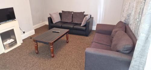a living room with a couch and a coffee table at HESFORD (A) in Manchester