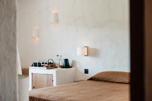 a bedroom with a bed and a table with lamps at Aguamadera in Santa Eularia des Riu