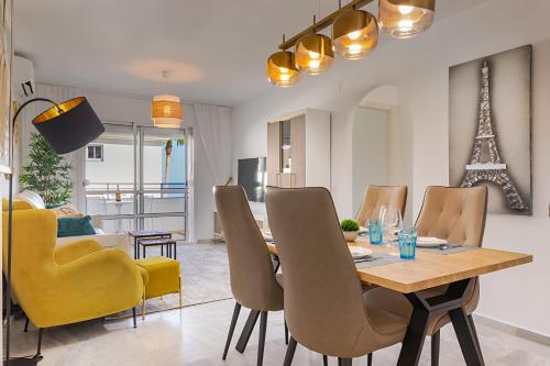 a dining room and living room with a table and chairs at Relax at Premium Beach flat - Aldea Beach in Manilva