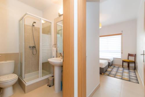 y baño con ducha, aseo y lavamanos. en Casa Nobre 2BDR Apartment w Pool & Patio en Conceição