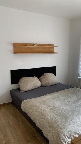 a bedroom with a bed with two pillows on it at Apartmány na Vršku in Plzeň