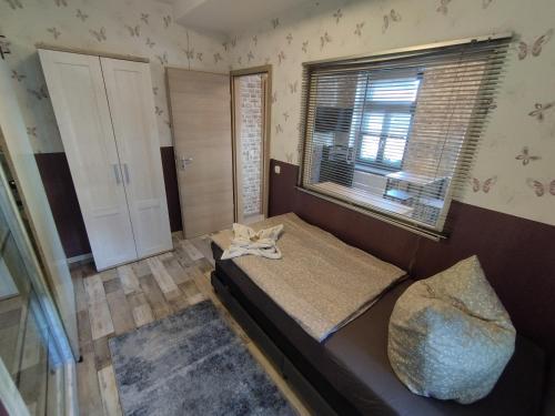 a small room with a bed and a window at Haus Oberkassel in Bonn