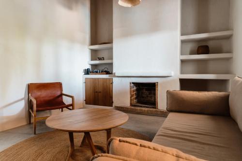 a living room with a couch and a table and a fireplace at Aguamadera in Santa Eularia des Riu