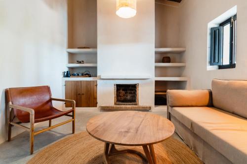 a living room with a couch and a table and a fireplace at Aguamadera in Santa Eularia des Riu